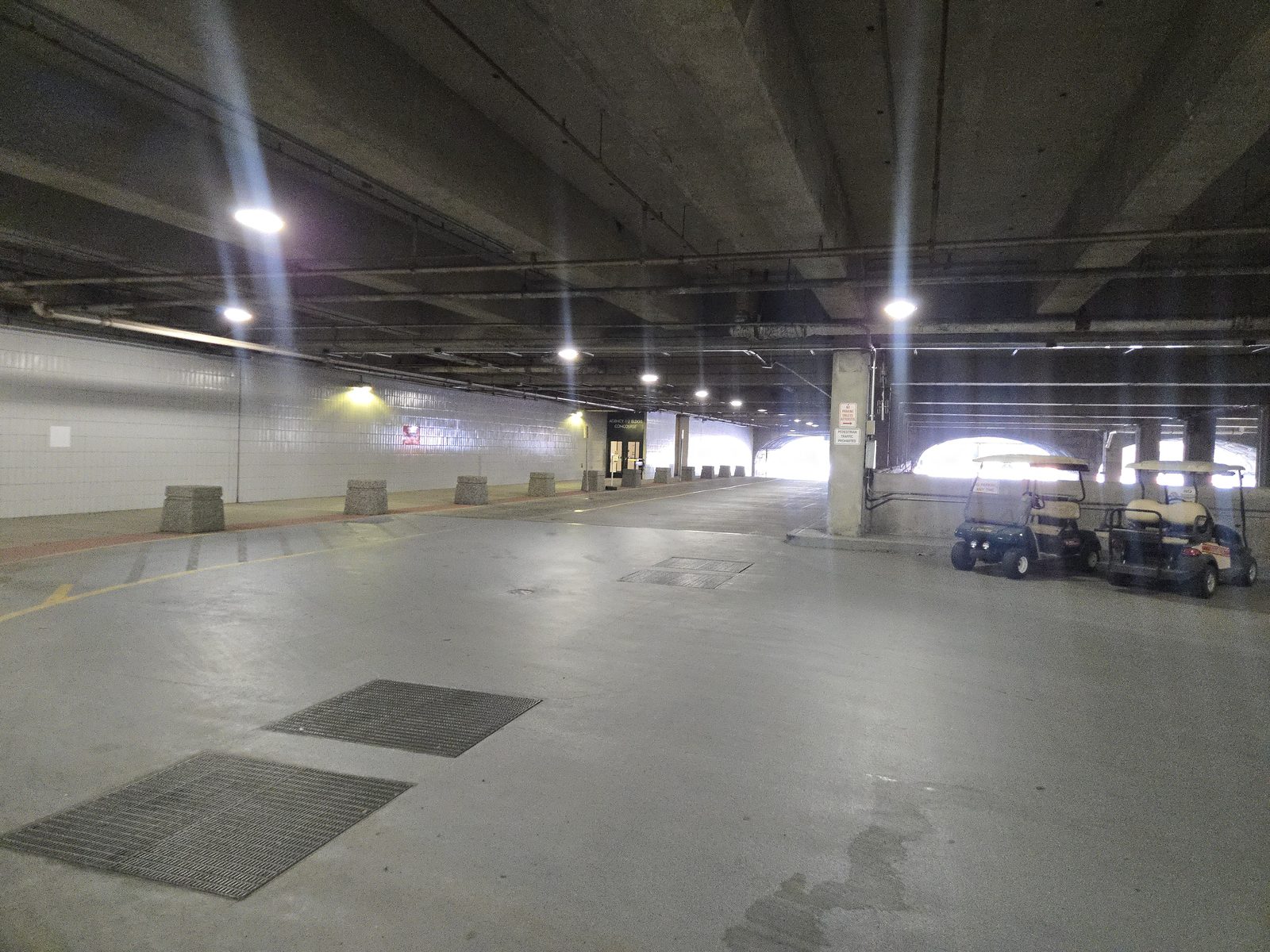 The enclosed Plaza service deck roadway, with the arched arterial portals letting in daylight at the far end.